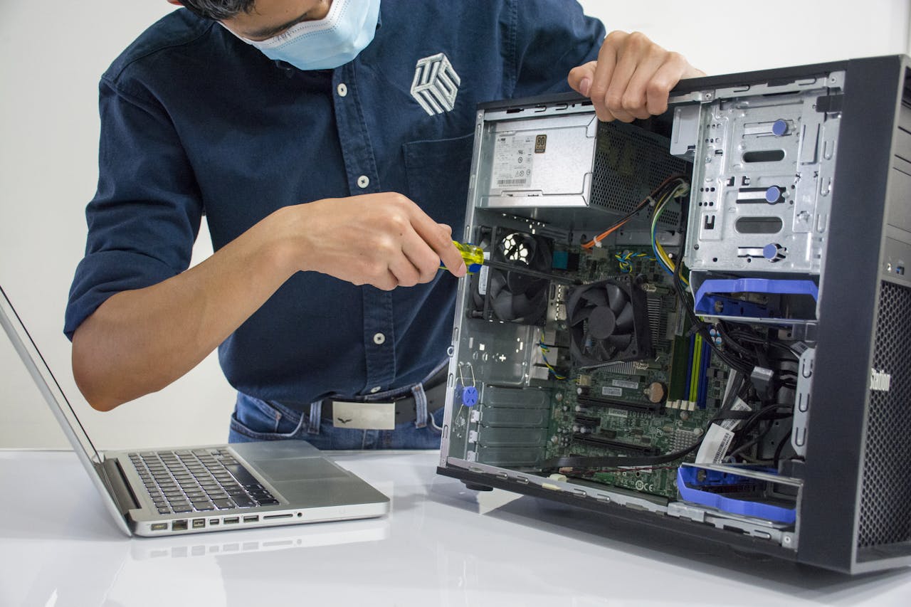 Home A technician repairs a desktop computer in an indoor setting, illustrating tech maintenance.