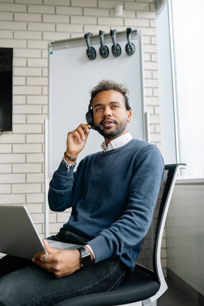 The Art of Drawing Readers In: Your attractive post title goes here Confident young call center agent working with laptop and headset in a modern office setting.